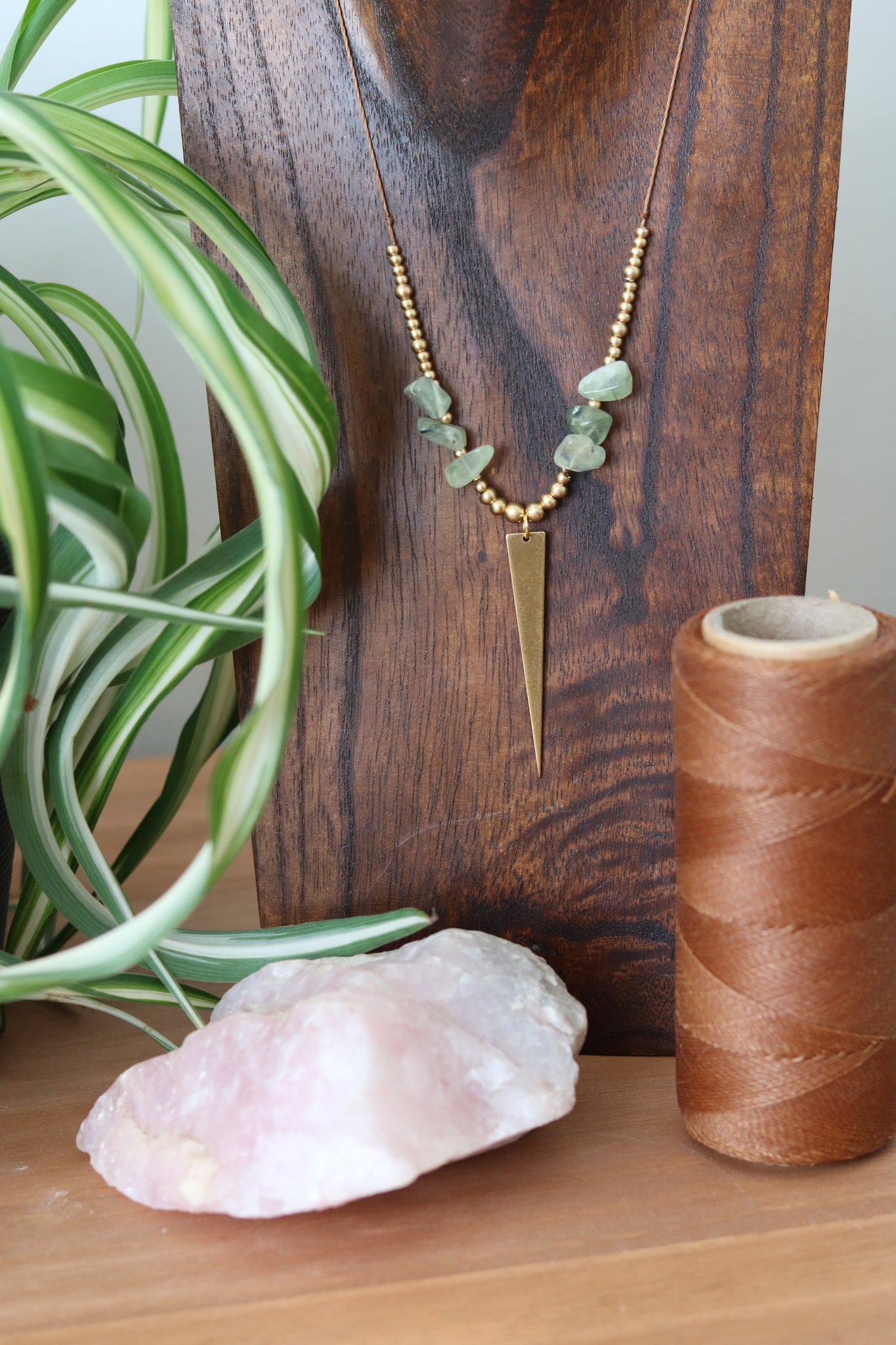 Pendant with stone chip and long pointy charm