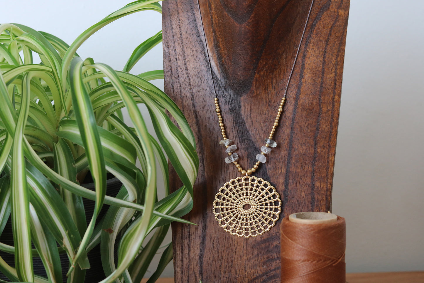 Pendant with stone chip and mandala charm