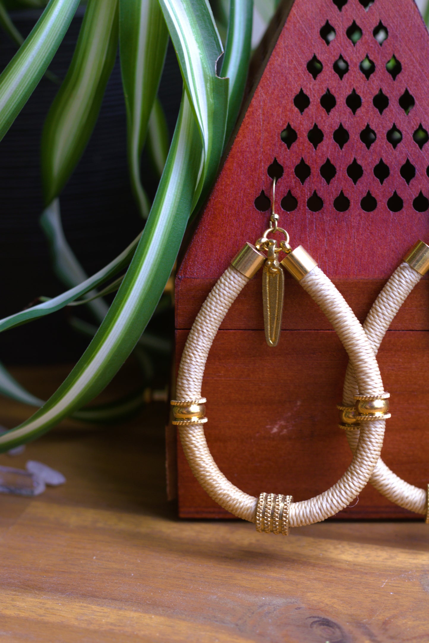 Beige earrings with charm