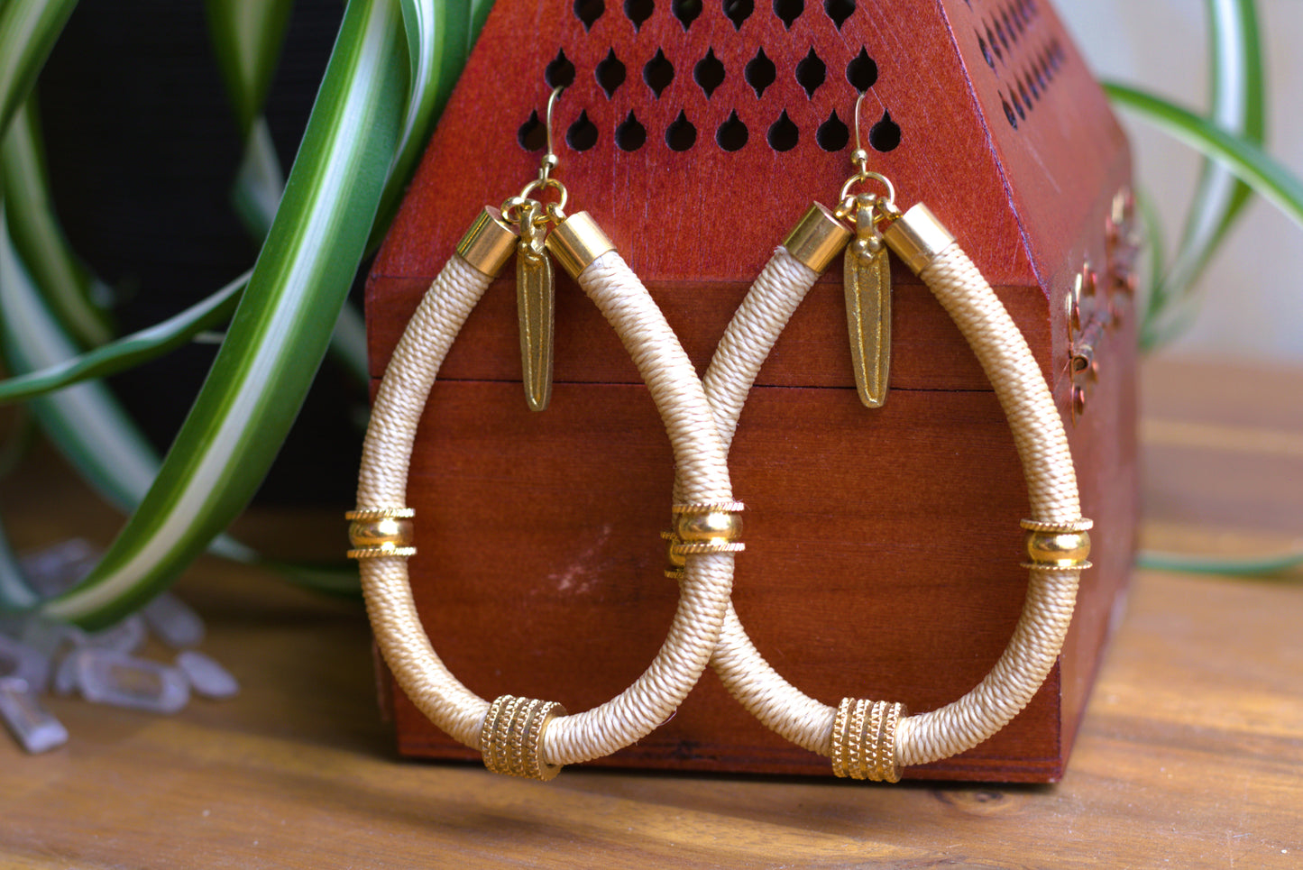 Beige earrings with charm