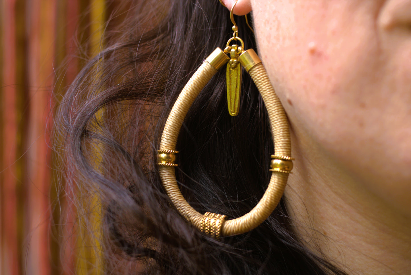 Beige earrings with charm